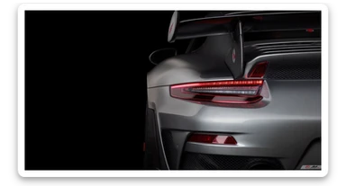 a stunning close-up of a porsche 911 gt3 rs , set against a black solid background. sticker