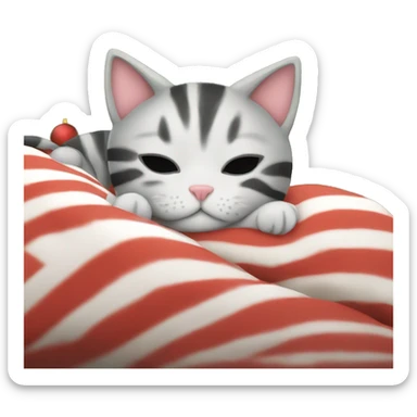 striped kitten sleeping in bed next to christmas tree sticker
