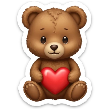 A tiny brown teddy bear next to a brown heart sticker