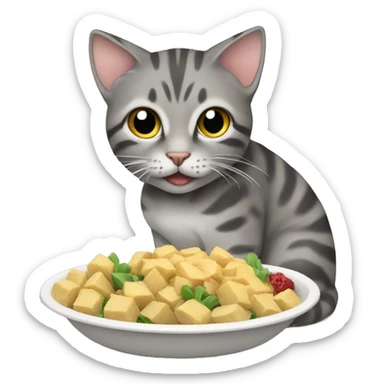 gray tabby cat eating sticker