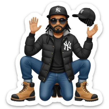 African American man with shoulder length black dreadlocks with black beard wearing black sunglasses wearing a black New York Yankees logo baseball cap wearing a black bubble winter coat wearing denim skinny jeans and timberland boots putting on his shoes sticker
