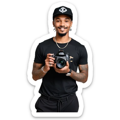 A young, black, South African, male cinematographer dressed in a black round neck t-shirt, black pants and black baseball cap holding a mirrorless dslr camera in one hand. Dark brown eyes. Bright white smile. Minimal facial hair — a small moustache connected to a goatee. Arms covered in tattoos. sticker