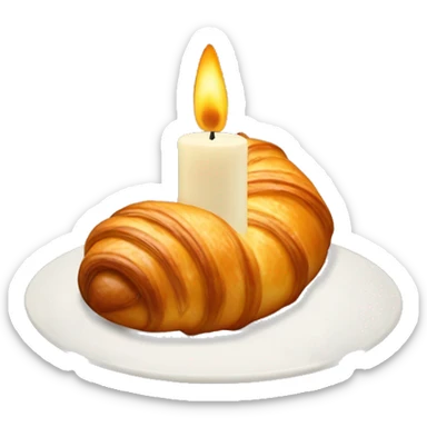 a candle in the shape of a croissant, felines sticking out of the croissant sticker