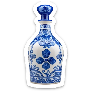 The Clase Azul Tequila bottle has a tall, hourglass-shaped ceramic body, hand-painted in white with cobalt blue floral designs. It’s topped with a distinctive gray, bell-shaped stopper that adds a final elegant touch. sticker