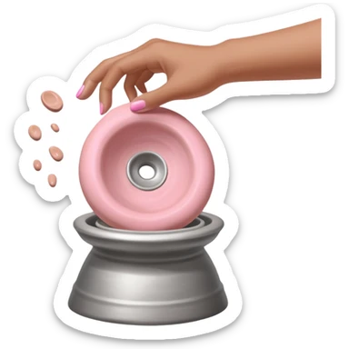 single hand caught mid-action of throwing a pink clay blob that is already placed on a silver pottery wheel sticker