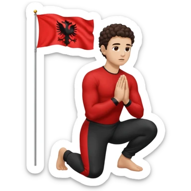 Brunette man clean shaven with slick back curly hair on his knees praying to an Albanian flag sticker