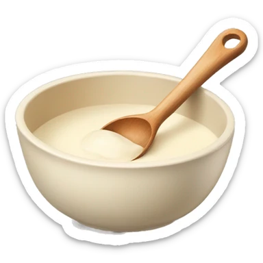 A cream ceramic baking bowl with a wooden spoon in it sticker