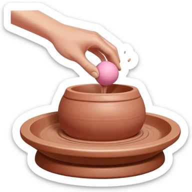 one hand throwing a pink ball of clay onto a pottery wheel sticker