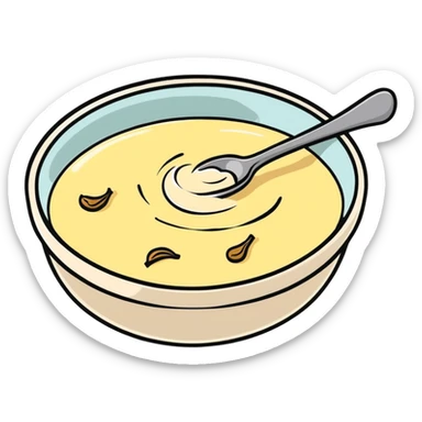 creamy alioli sauce in a small dish with garlic cloves nearby sticker