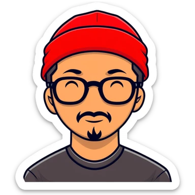 Asian man with black goatee, glasses, wearing a small red beanie sticker