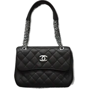 black Chanel purse with silver sticker