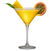 A yellow cocktail in a rounded martini glass with a passion fruit garnish sticker