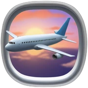 Airplane window with sunset sticker