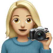 Short blonde in blue sweater holding camera sticker