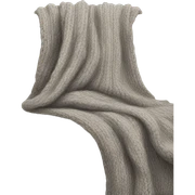 A soft beige sofa with a chunky gray knit throw draped over it sticker