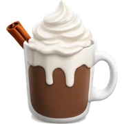 white mug of hot chocolate with whipped cream and cinnamon sticker