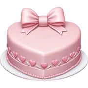 Pastel pink heart shaped cake with fancy white icing and bows sticker