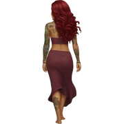 Beautiful tattooed  burgundy long haired woman walking on the beach sticker