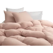 Dusty pink comforter and white pillows on bed sticker