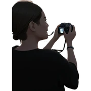girl holding camera at beach sticker