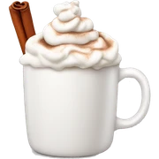 white mug of hot chocolate with whipped cream and cinnamon sticker