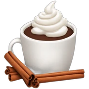 white mug of hot chocolate with whipped cream and cinnamon sticker