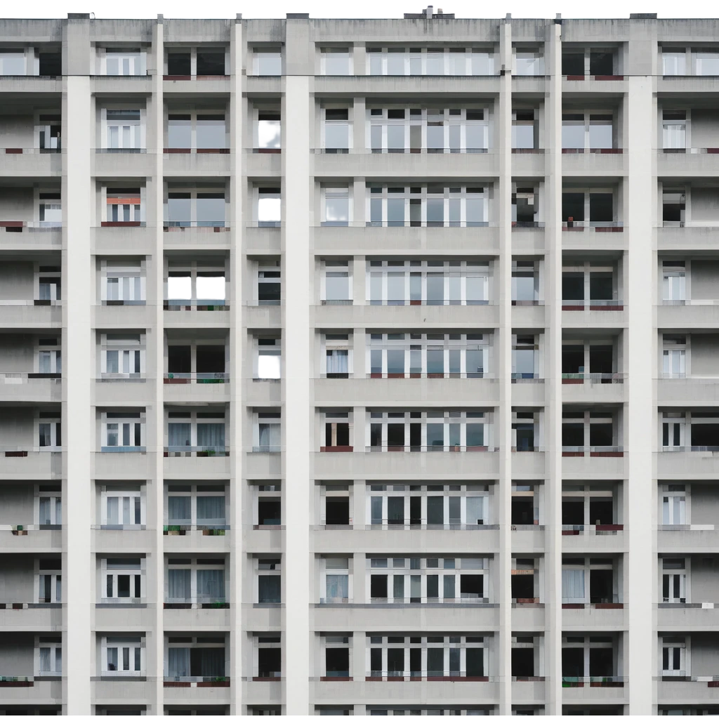 Soviet-era panel apartment building with rows of identical windows, gray concrete facade, flat roof, typical Russian multi-story residential building emoji