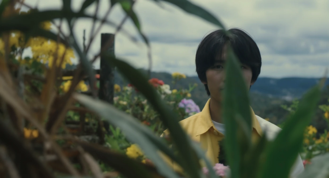 A portrait of a person in the foreground, blurred plants in the foreground (close to the camera), a wooden fence and colorfull flowers in the midground, rolling hills in the background, cinematic depth of field, layered composition, natural lighting emoji