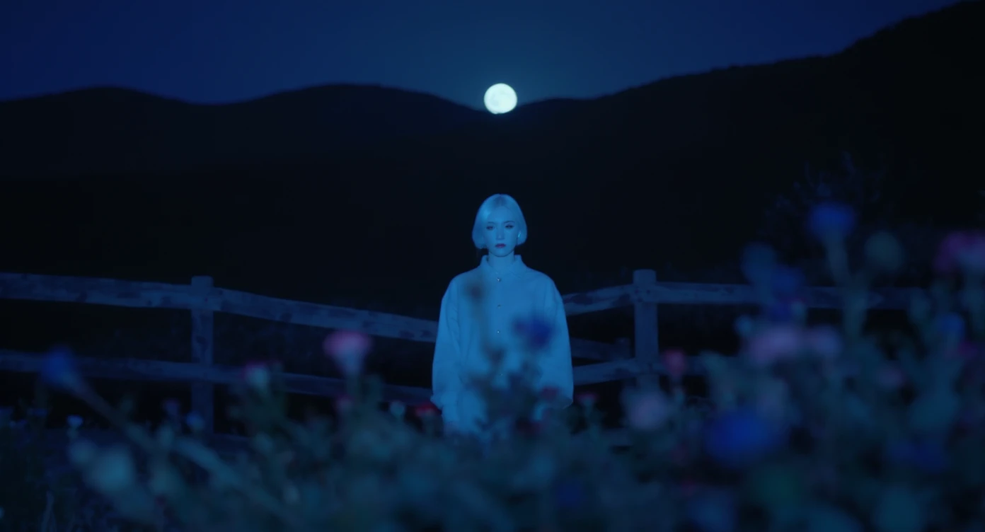 A portrait of a white person in the foreground, blurred plants in the foreground, a wooden fence and colorfull flowers in the midground, rolling hills in the background, cinematic depth of field, layered composition, moon back light (Blue night) emoji