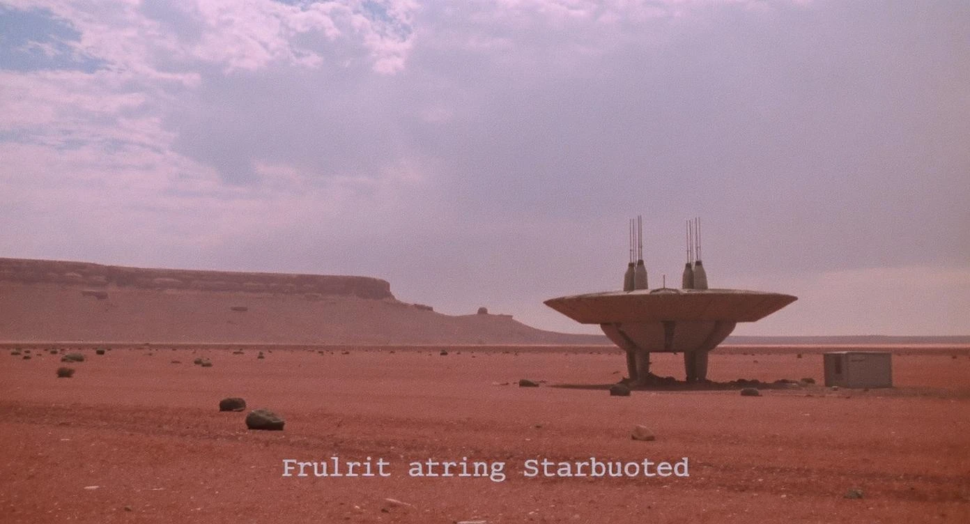 Cinematic still from 1990s Retro Space movie, film called Retro Futurism, Establishing scane showing desert with single small abandon futuristic bulding, big landscape in background showing loneliness emoji