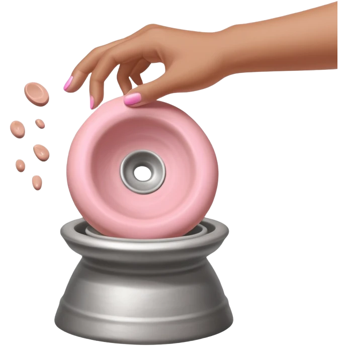 single hand caught mid-action of throwing a pink clay blob that is already placed on a silver pottery wheel emoji