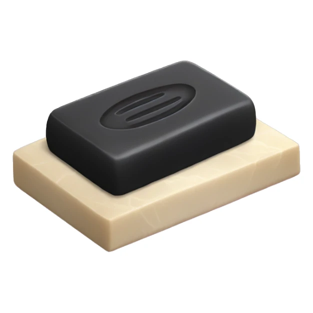 Black, rectangular, bar of soap laying flat on a fancy soap dish sticker