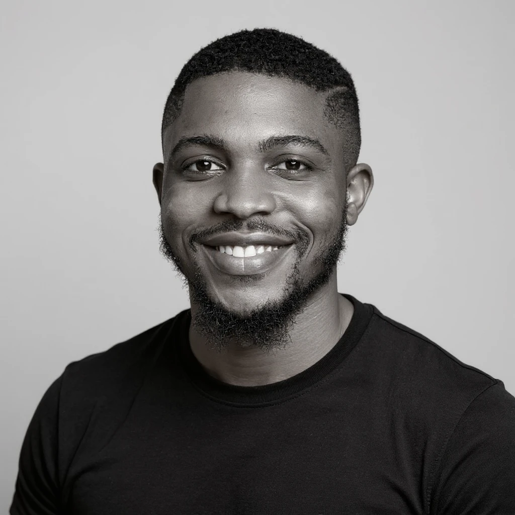 A professional portrait of me in monochrome. Plain black crew neck shirt. Tailored to LinkedIn. Tech boy vibe (programmer). I’m a black man from Nigeria. Retain facial features from attached image. Make face smoothie and healthy. No accessories. Light gray background to make subject more visible. emoji