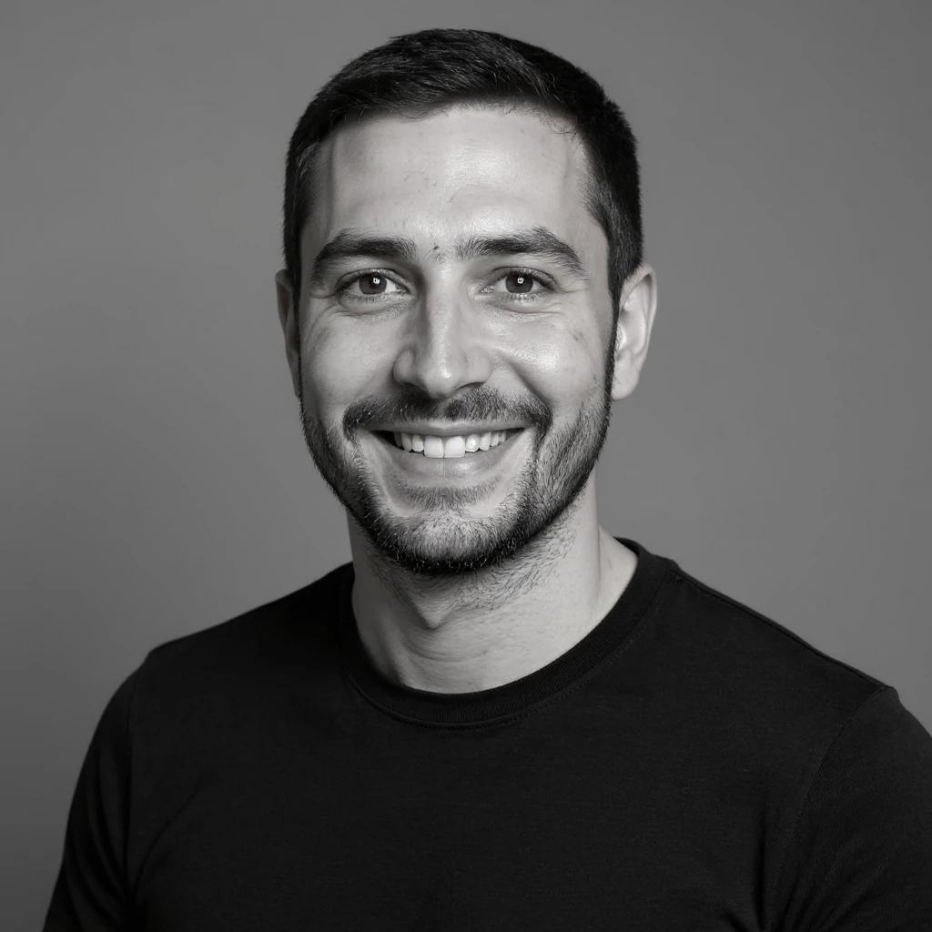 A professional portrait in monochrome. Plain black crew neck shirt. Tailored to LinkedIn. Tech boy vibe (programmer) emoji