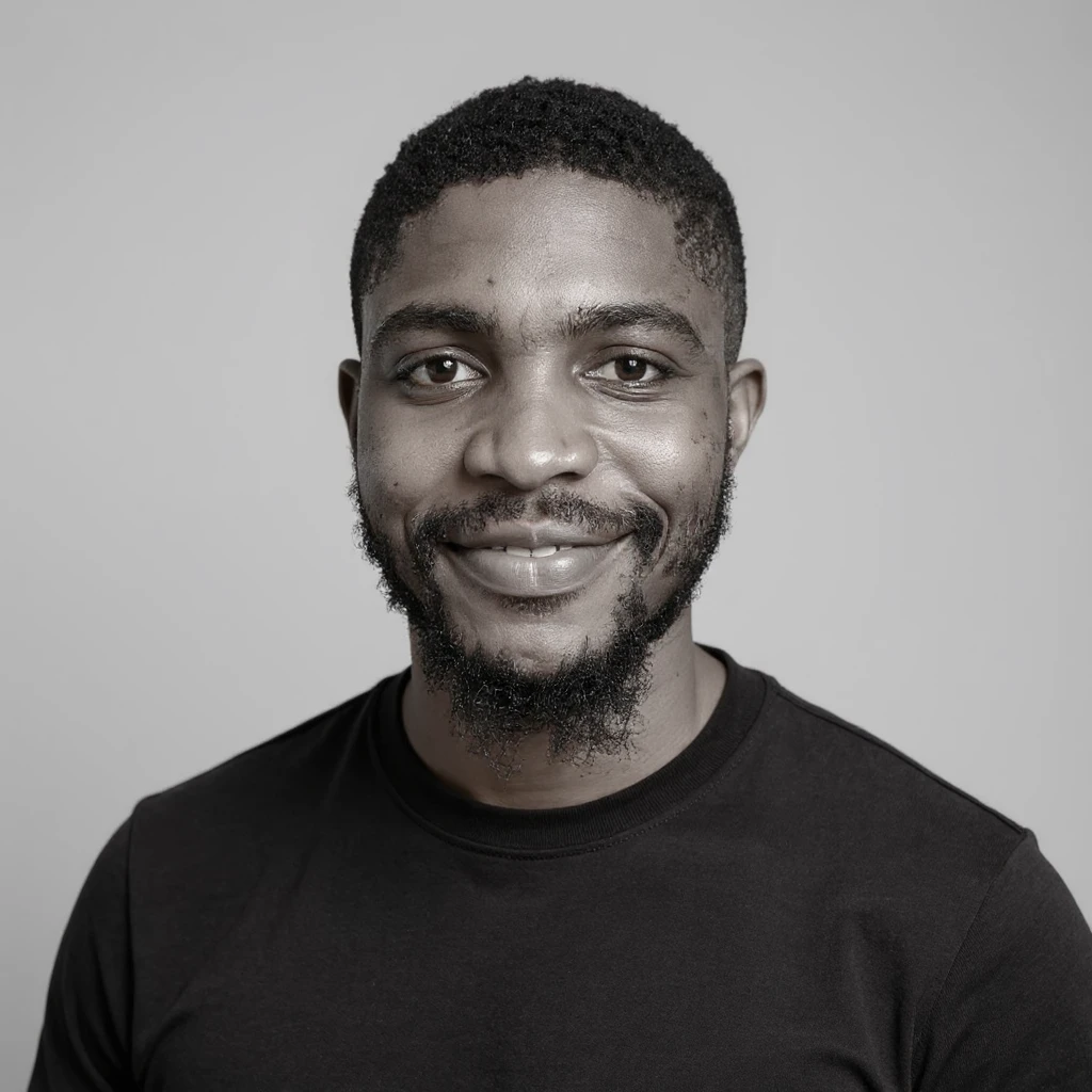A professional portrait of me in monochrome. Plain black crew neck shirt. Tailored to LinkedIn. Tech boy vibe (programmer). I’m a black man from Nigeria. Retain facial features from attached image. Make face smoothie and healthy. No accessories. Light gray background to make subject more visible. emoji