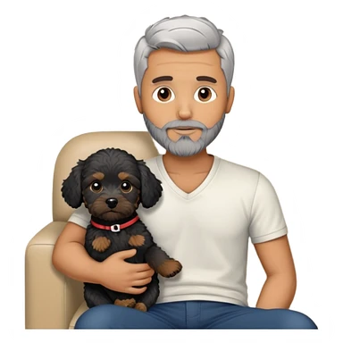 34 year old man with short straight grey hair and beard with A black cavapoo puppy with a white chest on the sofa sticker