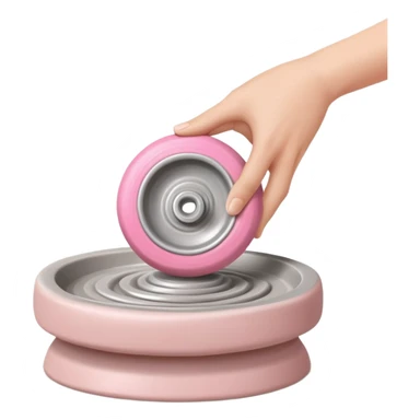 one hand throwing a pink ball of clay onto a flat silver pottery wheel surface sticker