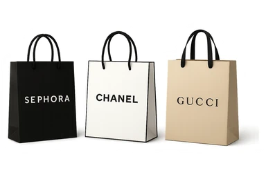 three shopping bags, each with a different luxury store logo: Sephora, Chanel, Gucci, elegant and upscale look sticker