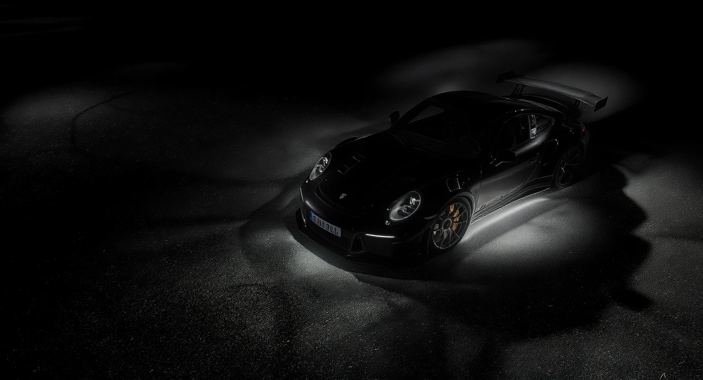 Editorial shot of a porsche 911 gt3 rs, top dutch angle, black voide around, top spotlight, captured on arri alexa emoji