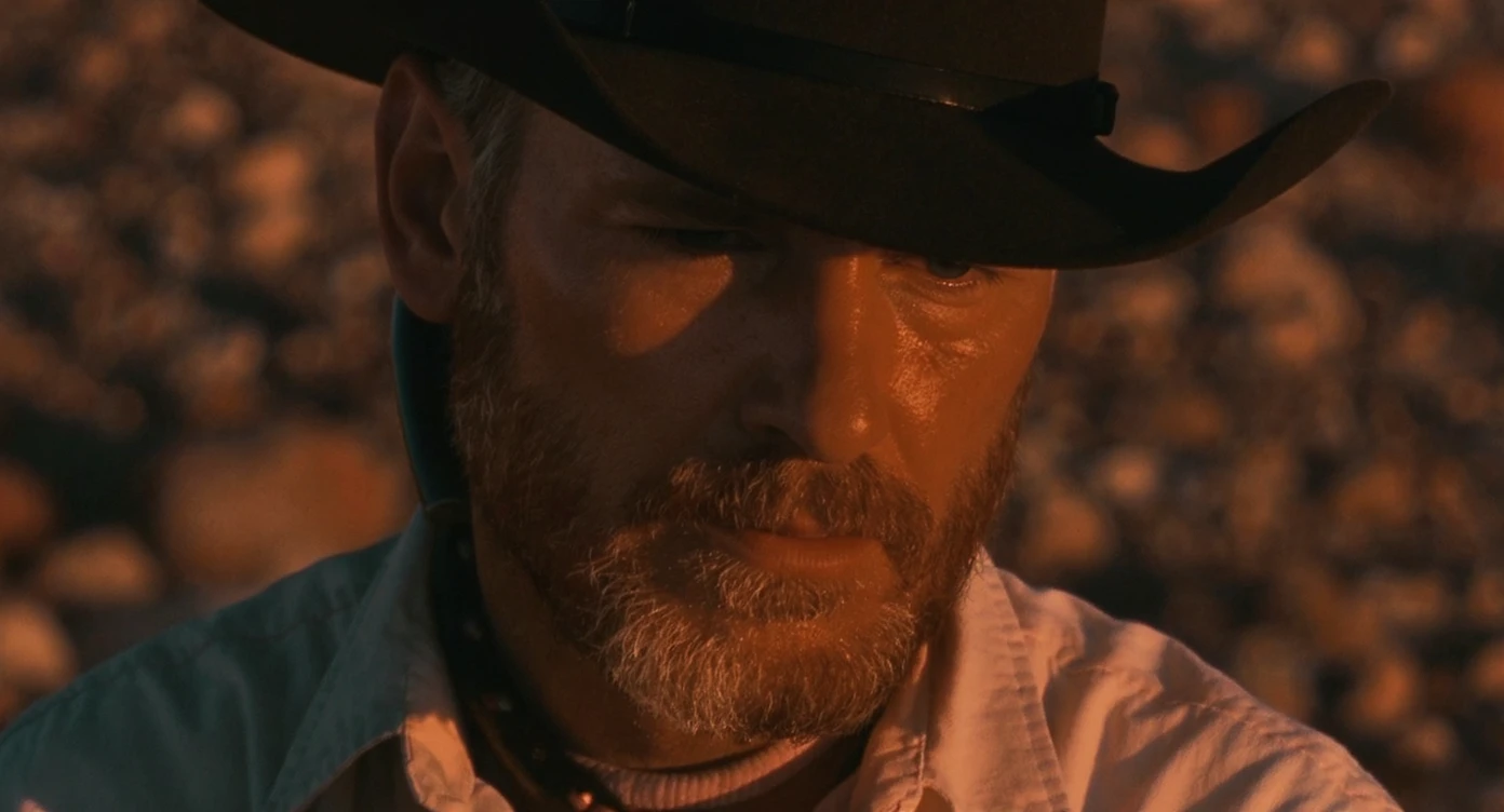 Cinematic , documentary photography, top angle medium shot, cowboy look eye brave, hard light golden hour, desert arizona, shot on arri alexa, 80s movie emoji