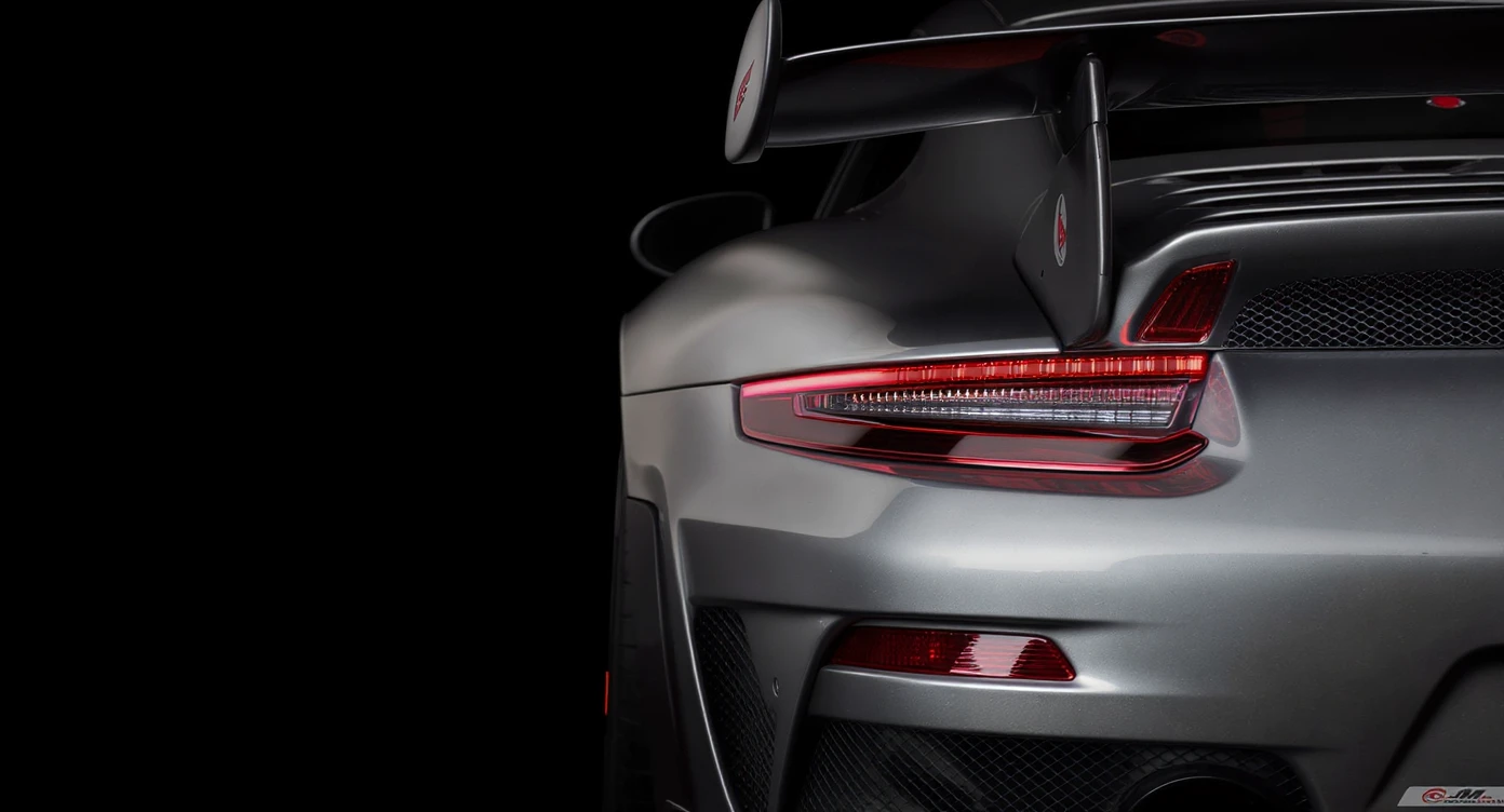 a stunning close-up of a porsche 911 gt3 rs , set against a black solid background. emoji