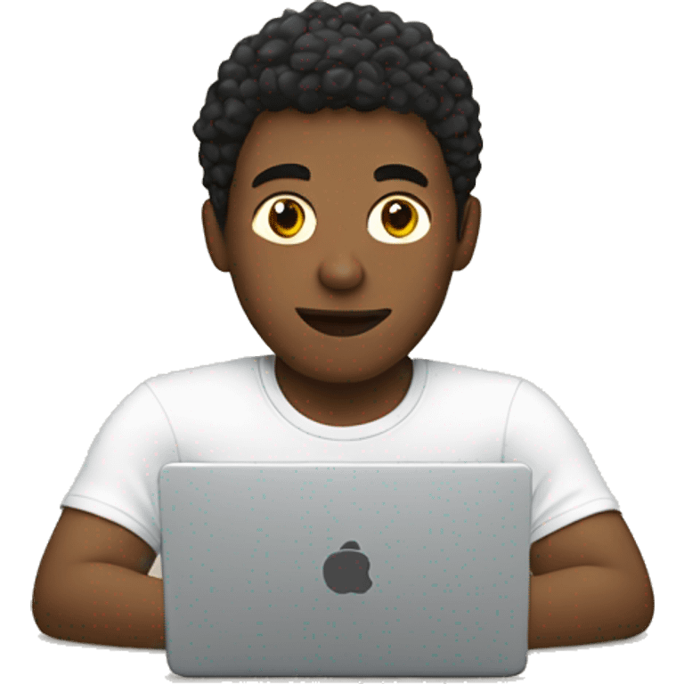 A white young man is sitting at a laptop in a T-shirt emoji