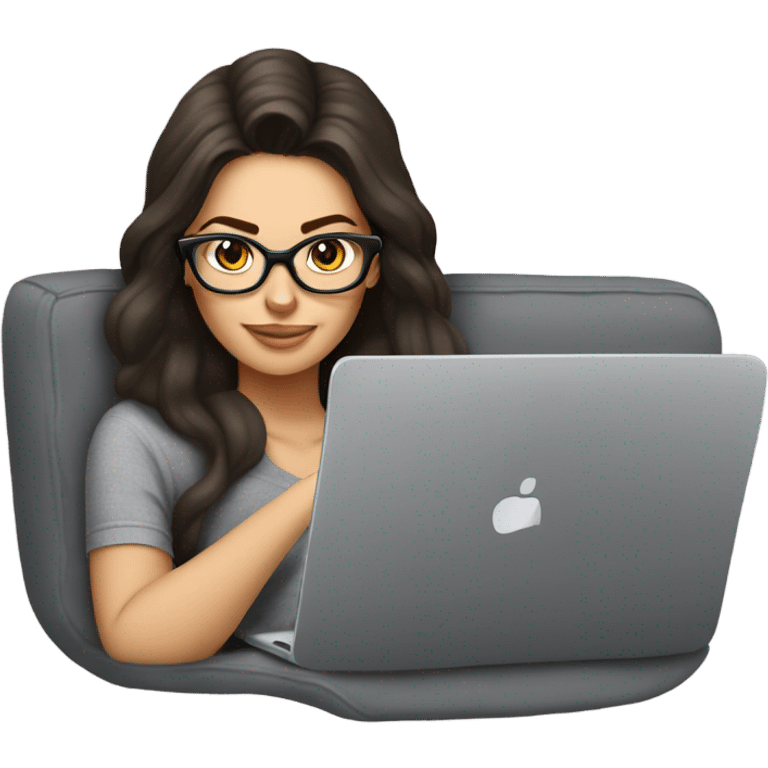 brunette girl laying on a grey couch with grey pillows with glasses on and a laptop on small table in front with coffee cup on mouse pad emoji